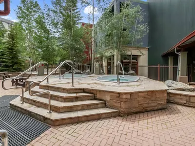 Two elevated hot tubs with stairs