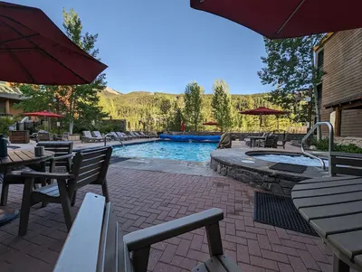 Pool and hot tub area in summer evening