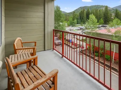Balcony with two teak chairs and mountain views