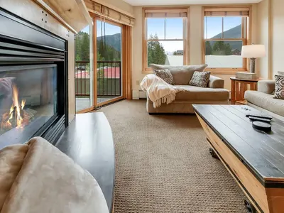 Living room with gas fireplace and mountain views
