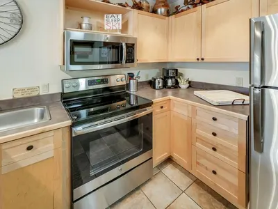 Kitchen close-up with stove, cabinets, and coffee maker