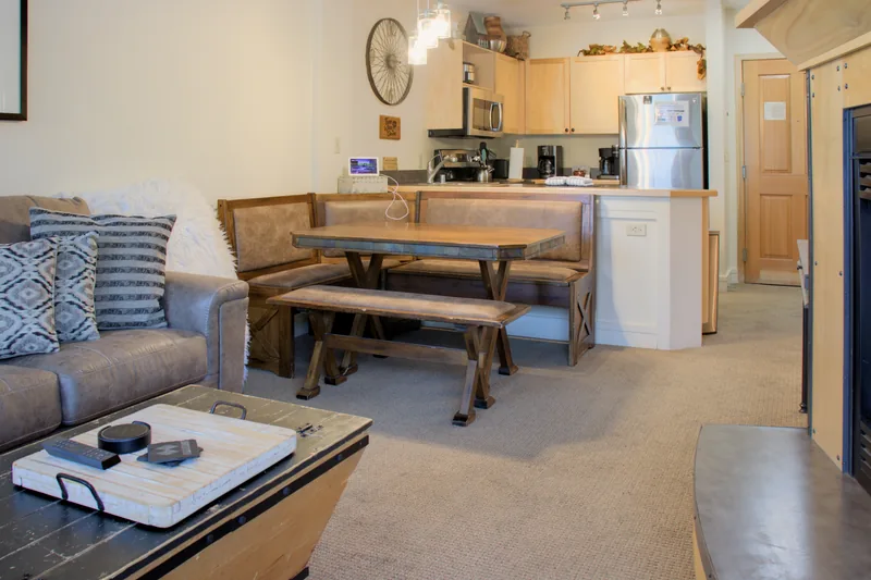 Dining table and bench with the kitchen and living area